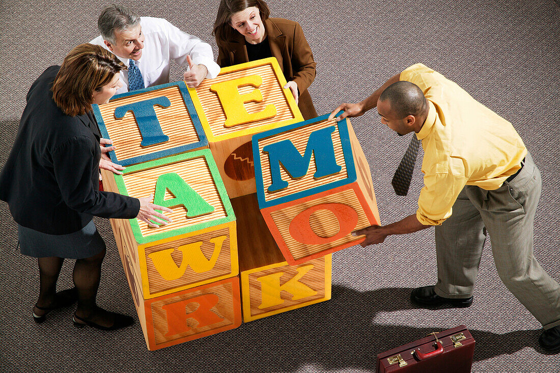 Businesspeople Putting Together Blocks