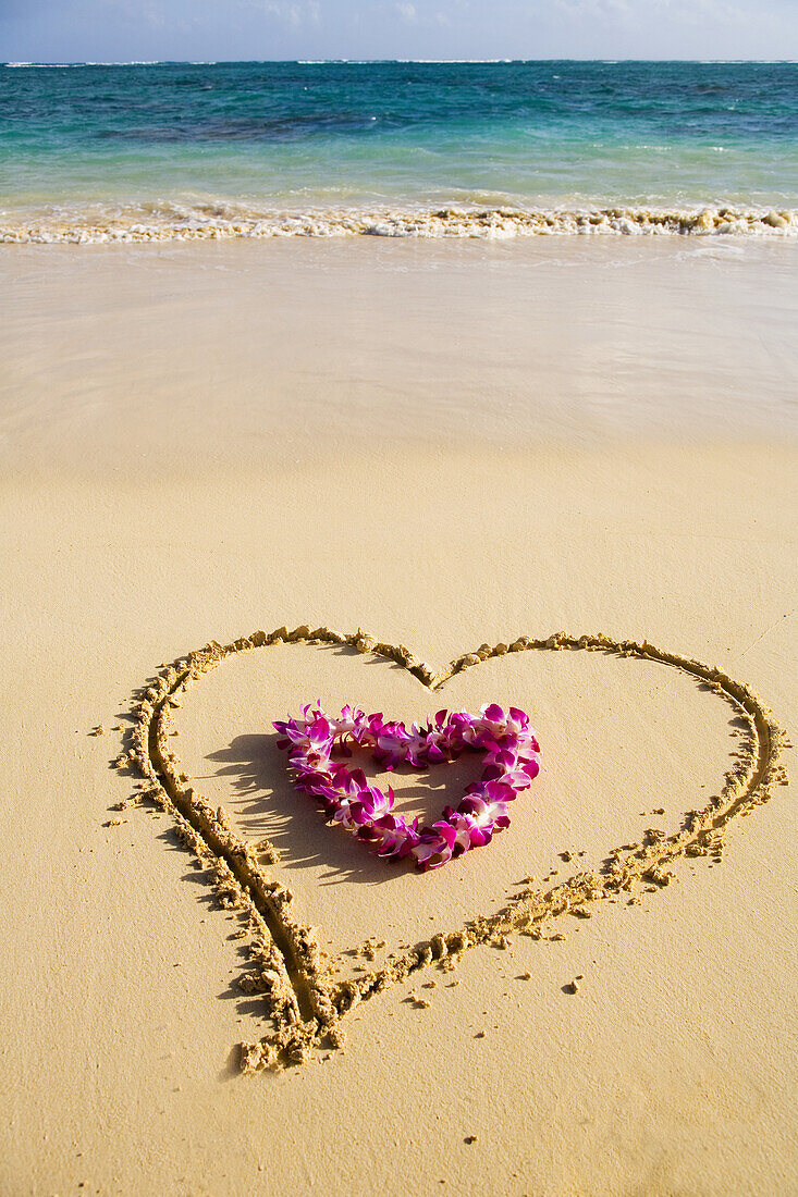 Picture Of A Heart Drawn In The Sand On A Tropical Beach, Orchid Lei Shaped Like A Heart Inside Of Drawing