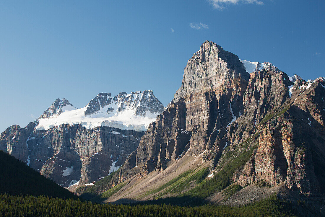 'Mountain Peaks With Cliff Face And Blue Sky; Alberta, Canada'