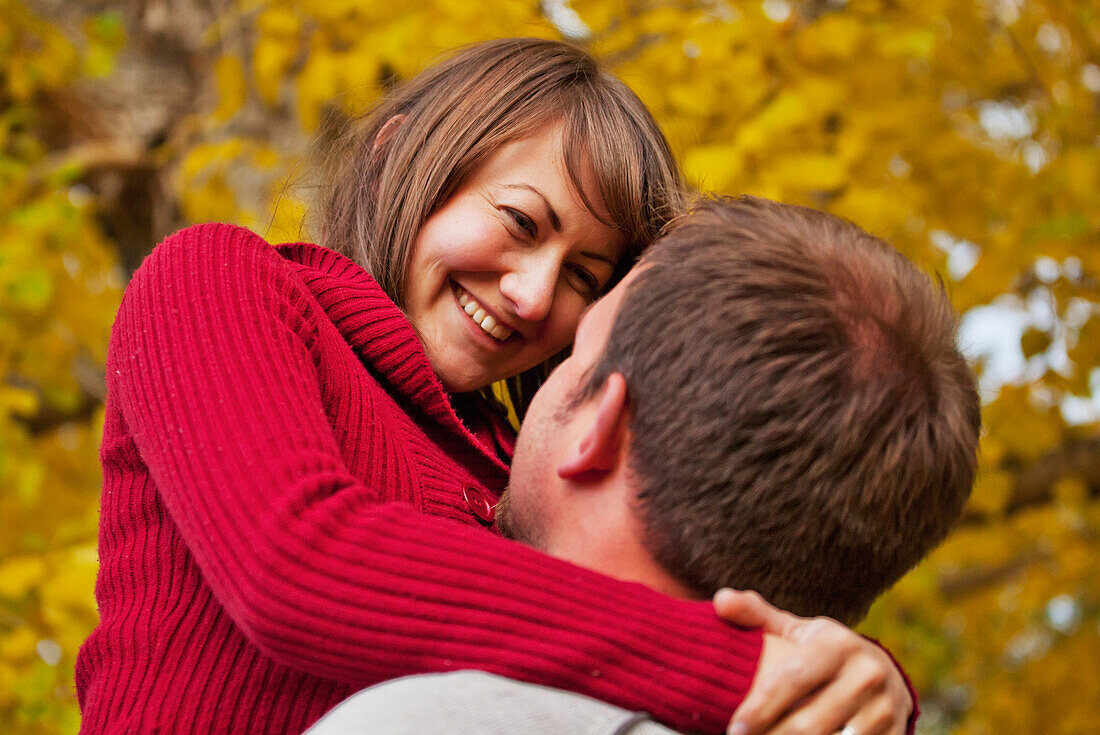 'Husband And Wife Together In A Park In Autumn; Edmonton, Alberta, Canada'