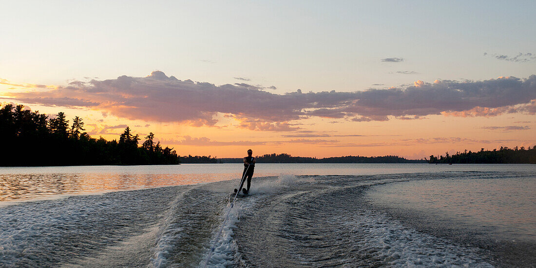 'Waterskier On The Lake At Sunset; Lake Of The Woods, Ontario, Canada'