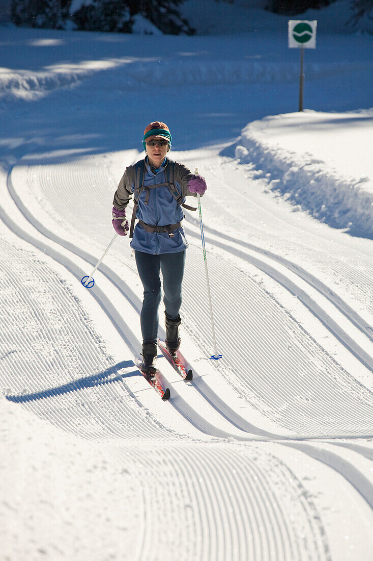 'Female Cross-Country Skier On Rolling Freshly Groomed Tracks In Kananaskis Country; Alberta, Canada'