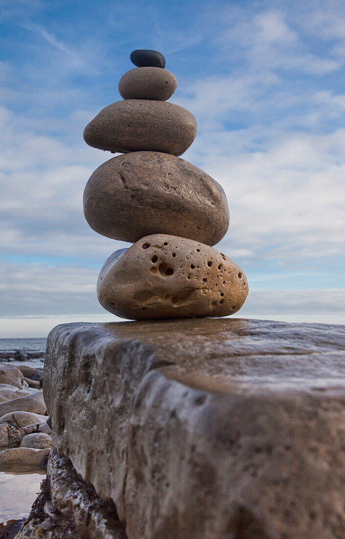 Rocks Balancing In A Pile From Largest To Smallest On A Boulder Along The Water's Edge South Shields Tyne And Wear England