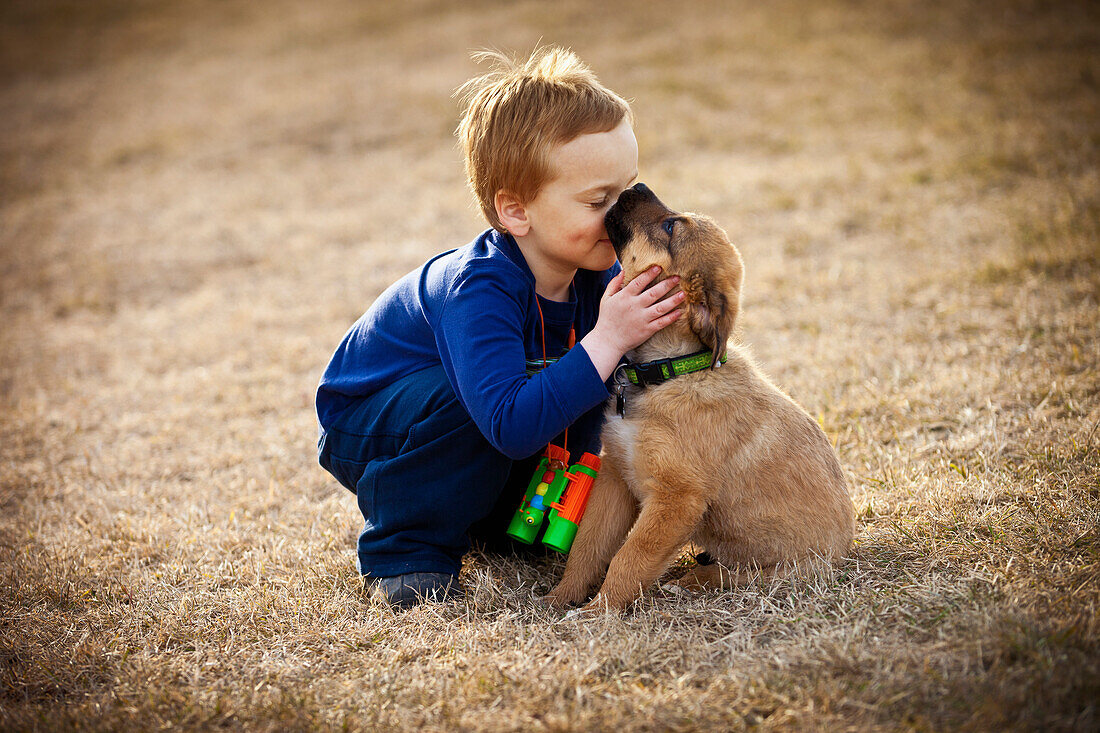'A Boys Shows Affection To His Pet Dog; Spruce Grove, Alberta, Canada'