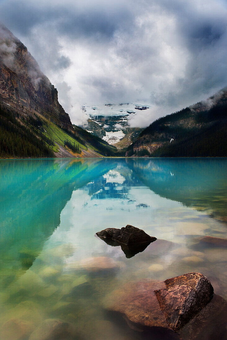 'Mountains Reflected In Tranquil Lake Louise; Alberta, Canada'