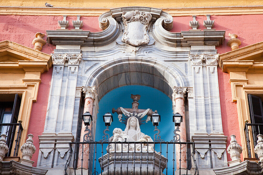 'Building with ornate facade and a sculpture with lights on a railing;Malaga andalusia spain'