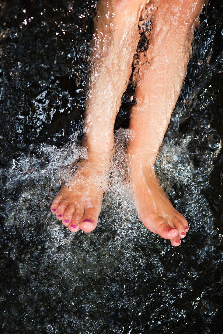 'Bare feet getting splashed with water at the currumbin rock pools;Gold coast queensland australia'