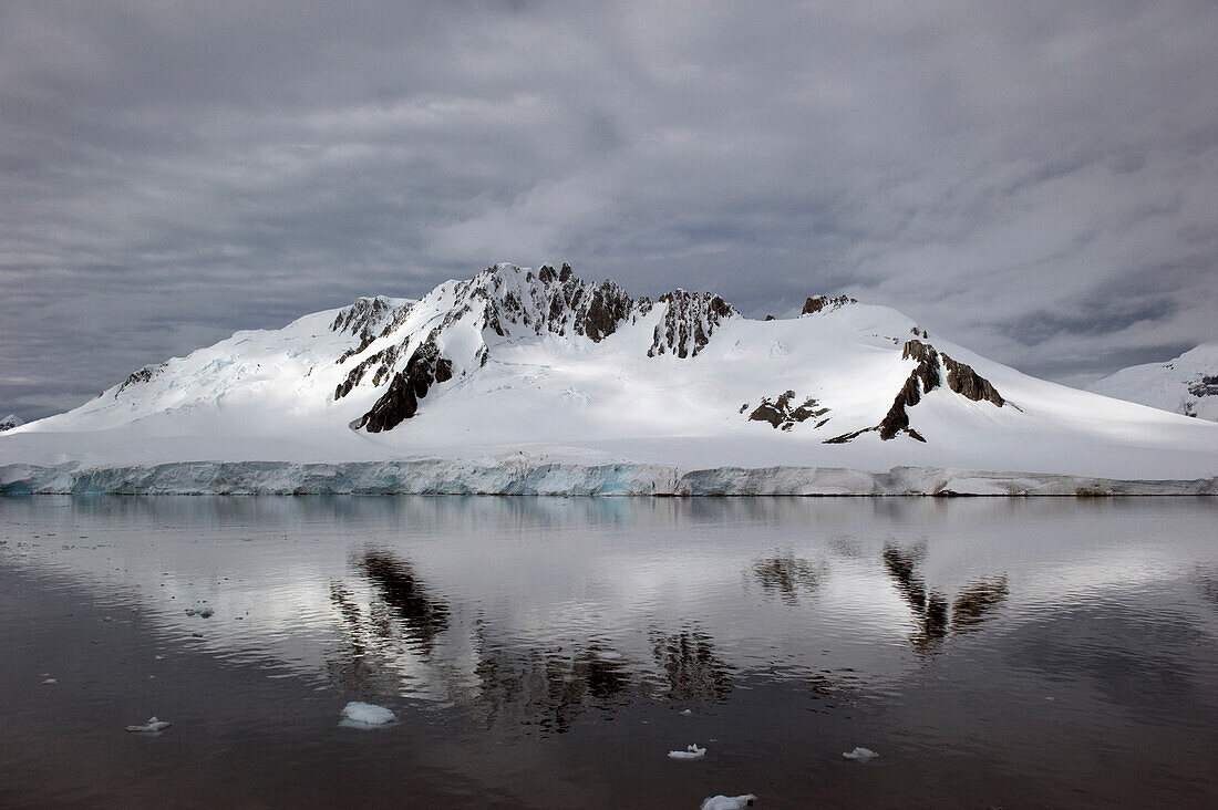 'A mountain reflected in the tranquil southern ocean;Antarctica'