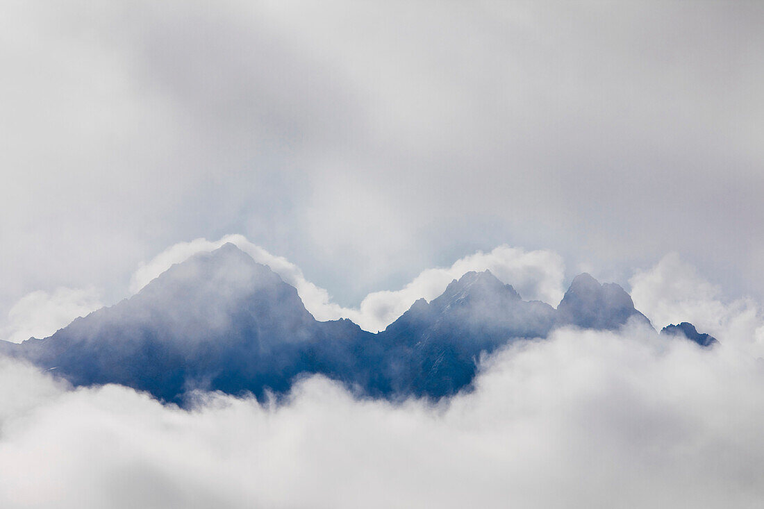 The Top Of The Twin Sisters Peaks Seen Through The Clouds, Palmer, Southcentral Alaska.
