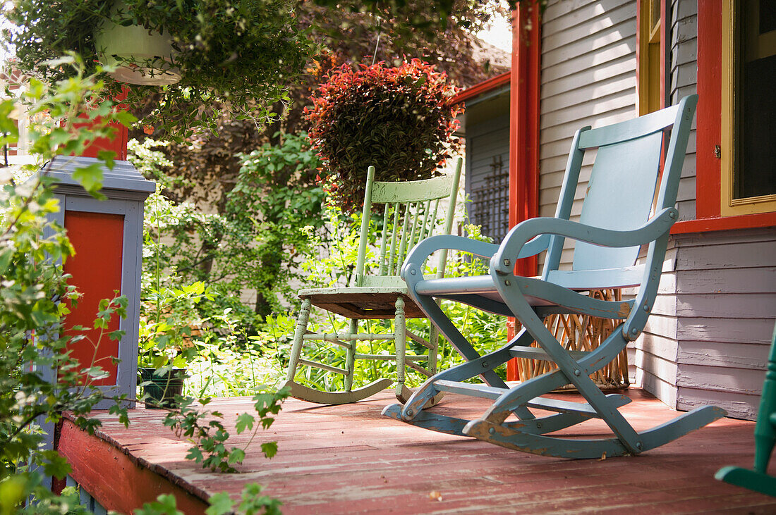'Two Chairs On A Deck In A Backyard Surrounded By Plants; Winnipeg Manitoba Canada'