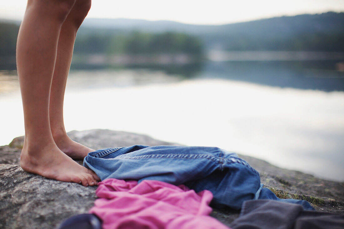 'Feet And Clothing On A Rock By A Lake; Kristiansand, Norway'