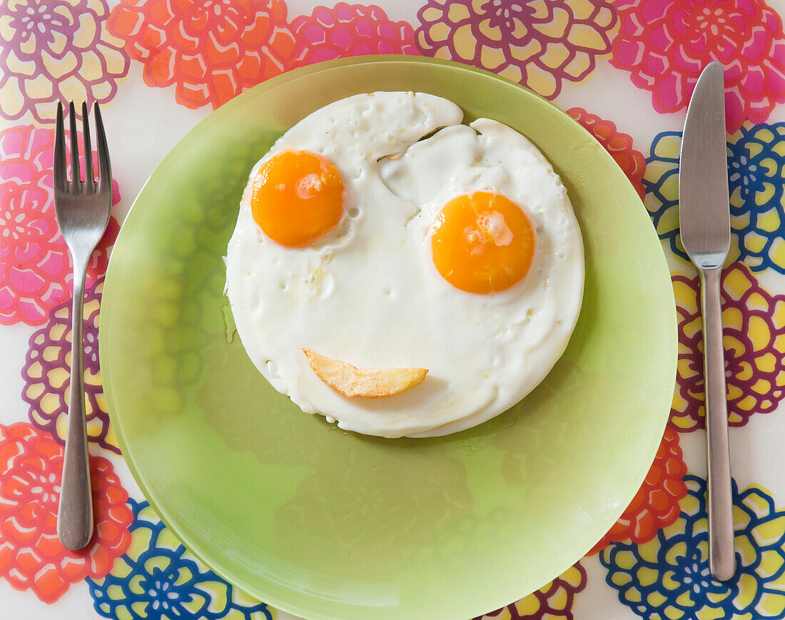 Two Eggs Making A Happy Face On A Plate