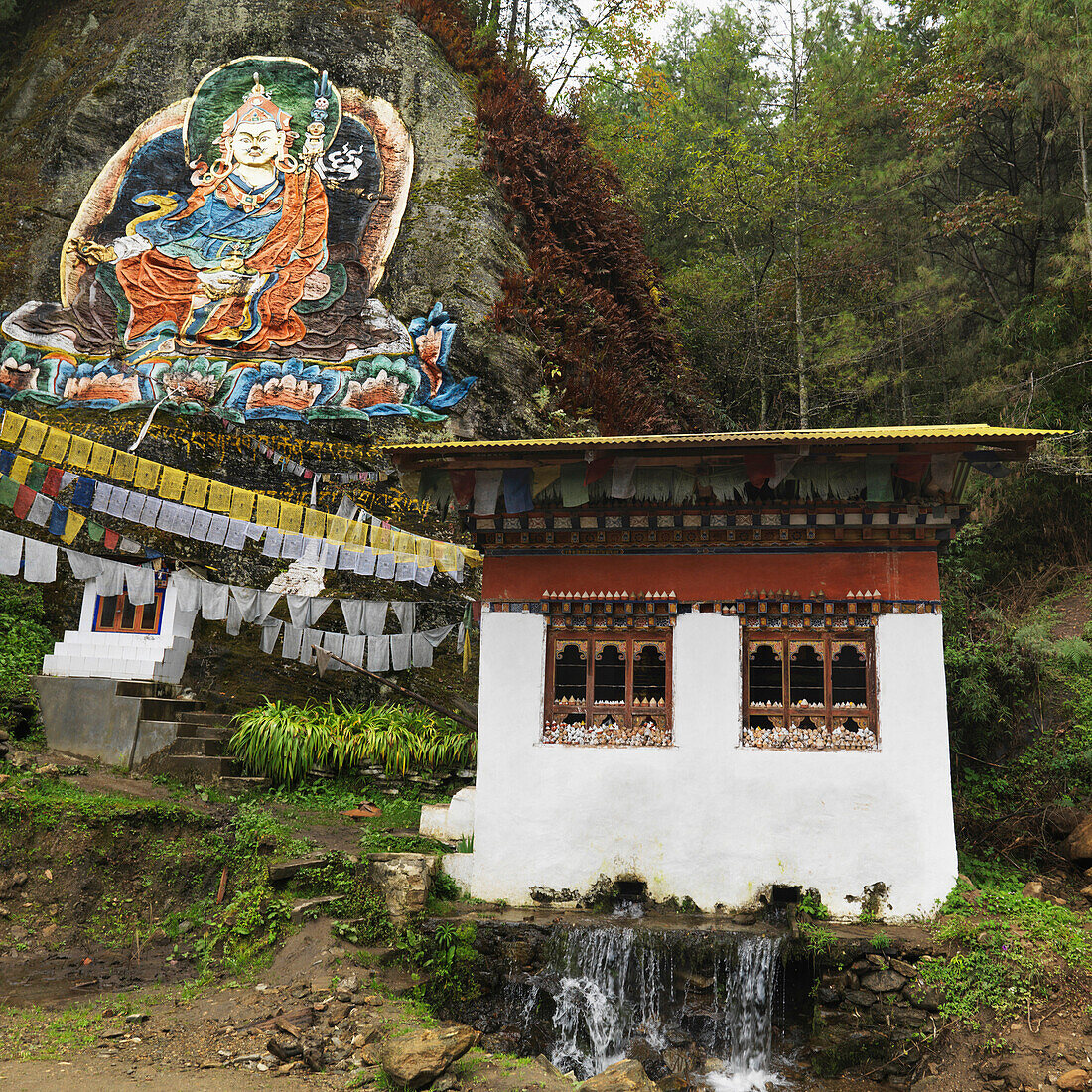 'Image Of Guru Rimpoche Above Prayer Flags And A Building; Begama Village, Punakha District, Bhutan'