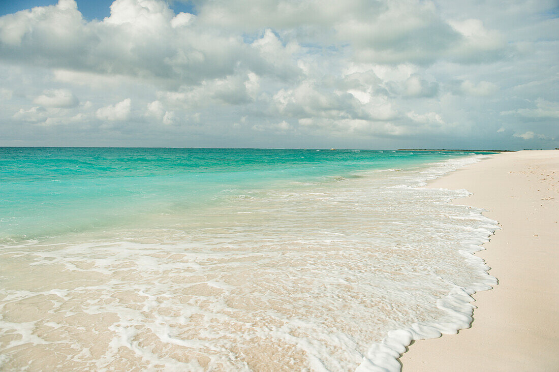 'Water Washing Up Onto The Sandy Beach; Providenciales Turks And Caicos Islands'