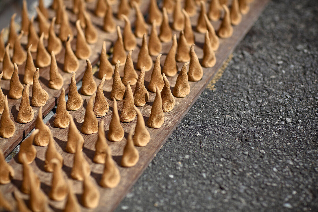 'Handmade Sandalwood Incense Dries In The Sun On The Street Side; Penang Malaysia'