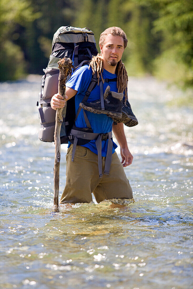 'Kananaskis, Alberta, Canada; Man Crossing A River'