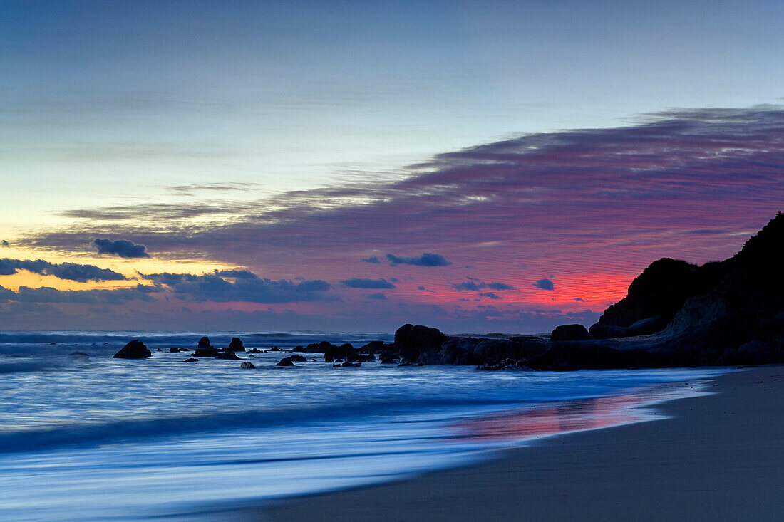 Sunset Over Water And A Beach