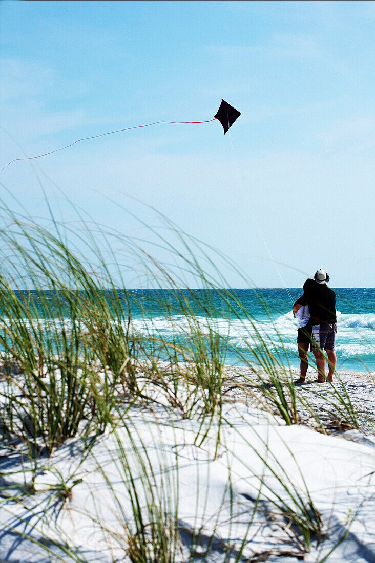 'Bradenton Beach, Florida, United States; Couple Flying A Kite On The Beach'