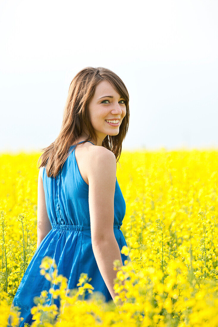 A Young Woman In A Canola Field