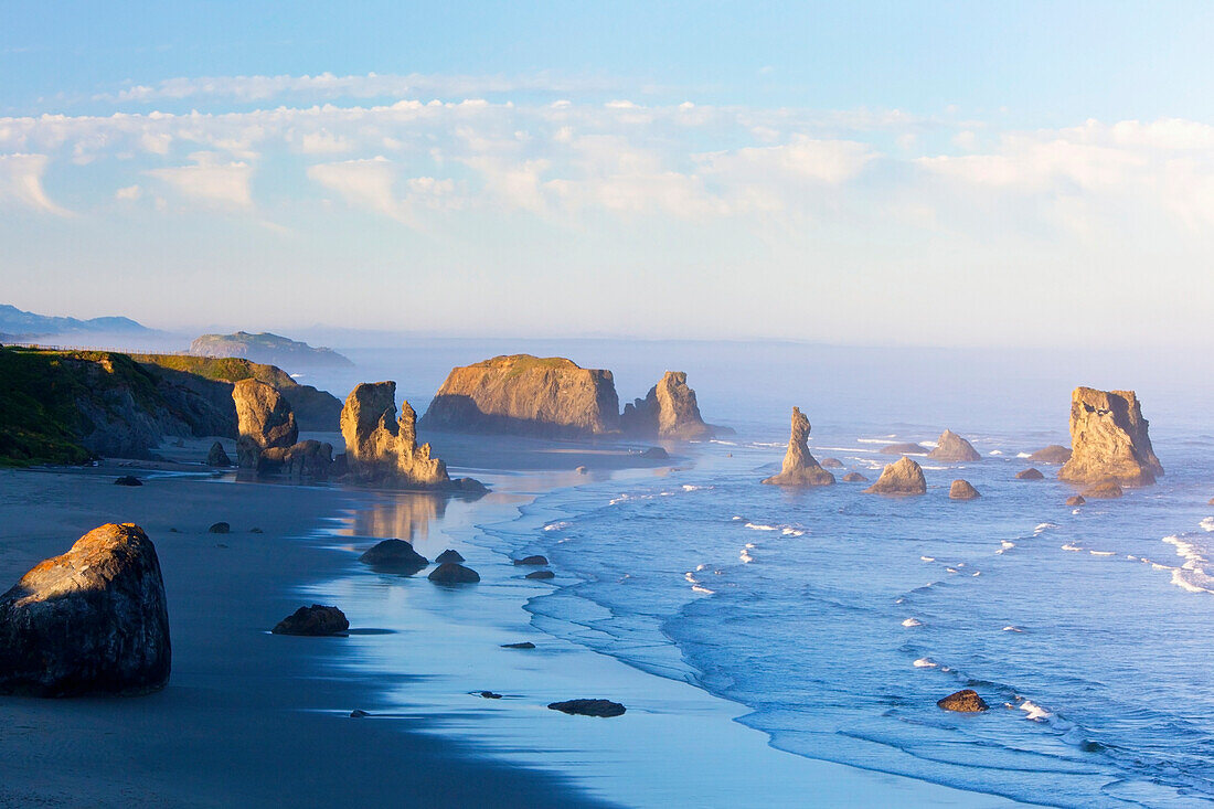 'Morning Light Adds Beauty To Fog Covered Rock Formations At Bandon State Park; Bandon, Oregon, United States of America'
