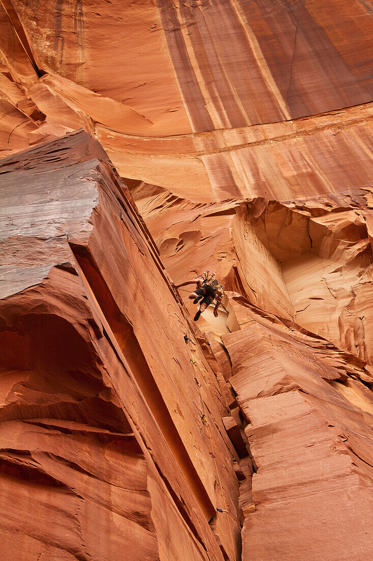 'A rock climber falling on an unnamed 5.11 on the Optimator Wall; Indian Creek, Utah, United States of America'