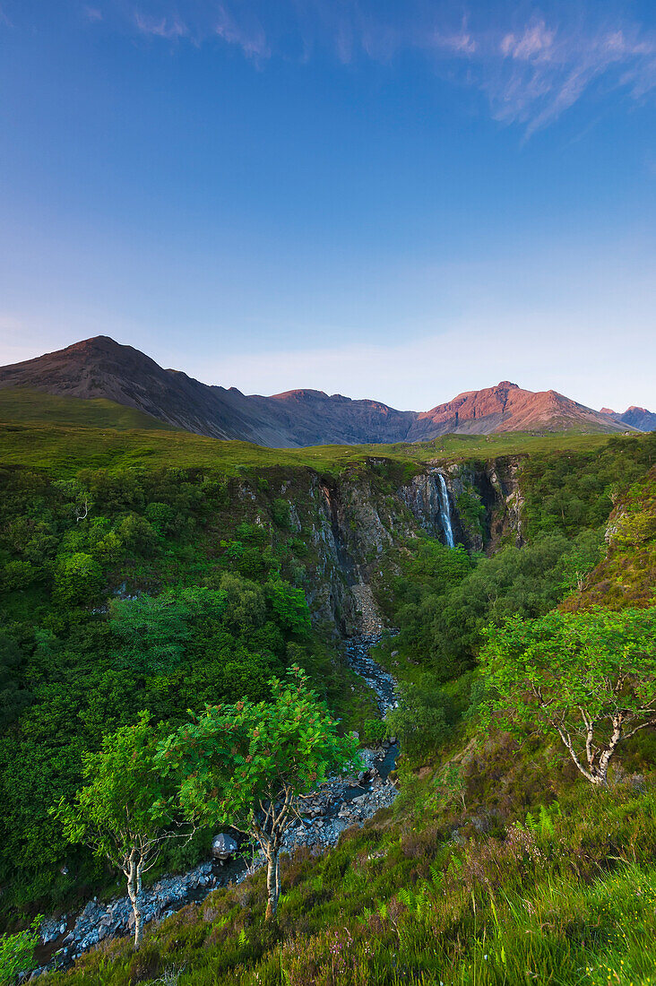 'Looking up river to the Eas Mor waterfall and the hills of the Black Cuillin at dusk; Isle of Skye, Scotland'