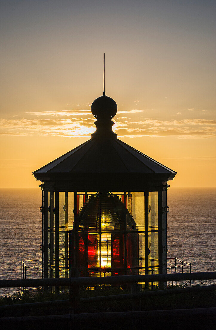 'The sun sets at Cape Meares Lighthouse; Oregon, United States of America'