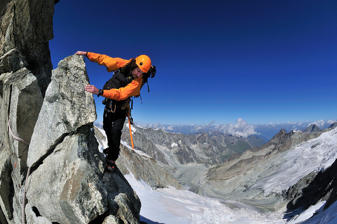 mountaineer climbing the Große Gendarm on the eastridge of Obergabelhorn (4034 m),  Wallis, Switzerland