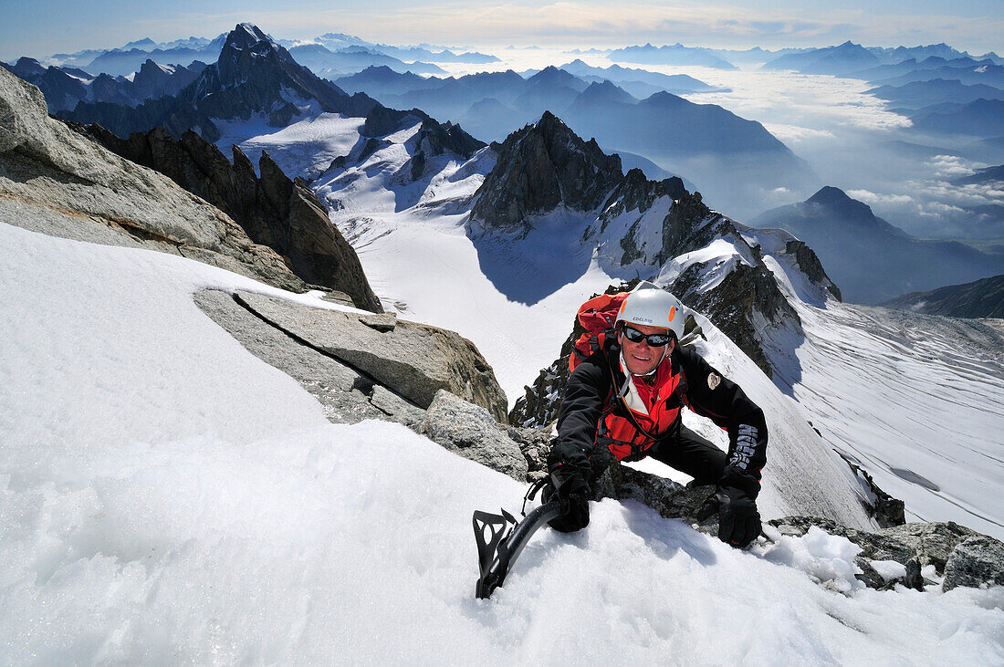 Mountaineer climbing the ridge of Tour Ronde, Mont Maudit, Mont Blanc Group, France