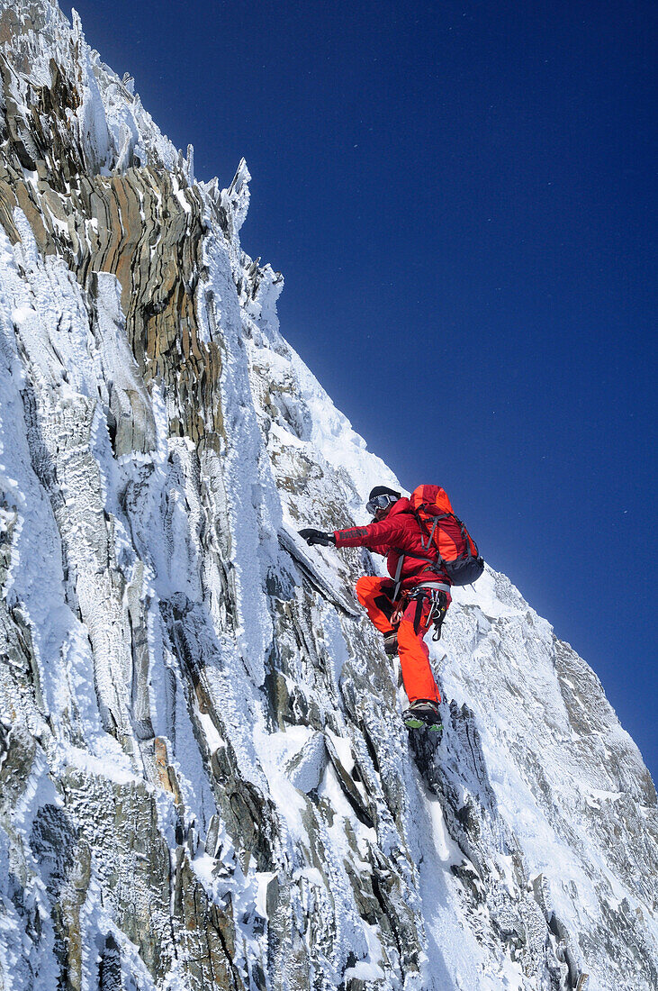 Mountaineer during snowstorm at Nadelhorn (4327 m), Wallis, Switzerland