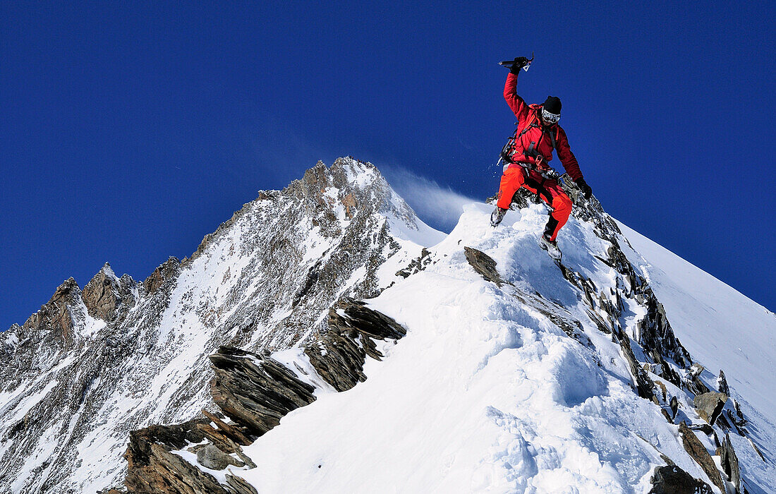 Mountaineer during descent from the summit of Nadelhorn (4327 m), Wallis, Switzerland