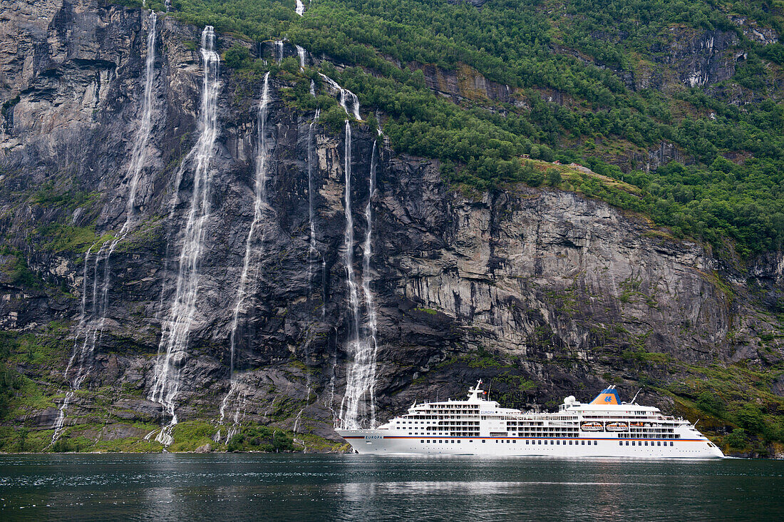 Cruise ship passing Seven Sisters Waterfalls, Geirangerfjorden, More og Romsdal, Norway