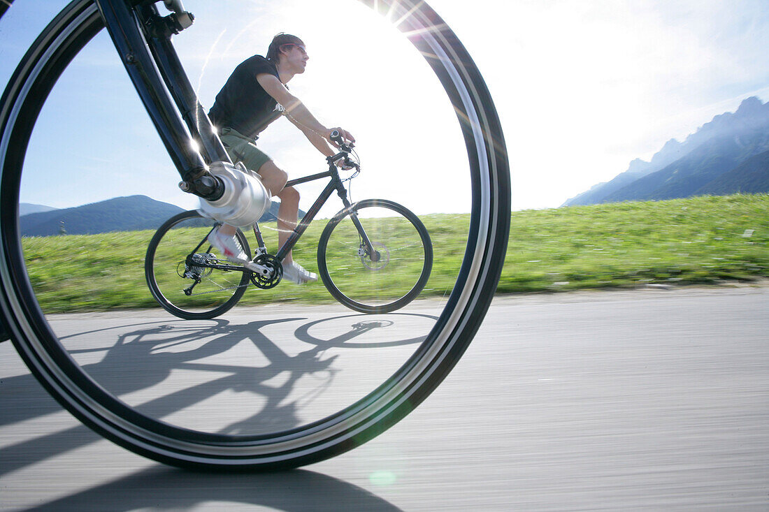 Persons mountain biking near Tre Cime di Lavaredo, Veneto, Italy