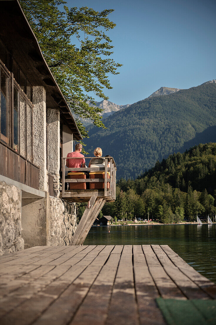 man and woman enjoying the view at Lake Bohinj and surrounding Alps, Bohinj around Bled, Slovenia, Europe