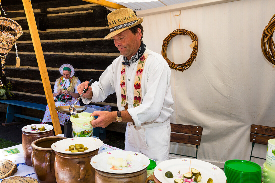 Farmer in traditional dress dishing out gherkins, Open Air Museum in Lehde, Spreewald, UNESCO biosphere reserve, Lübbenau, Brandenburg, Germany, Europe