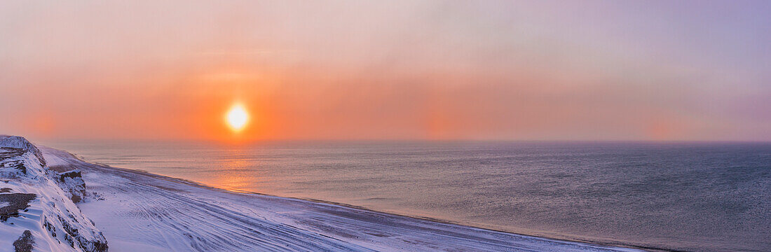 'Two sundogs hang in the air over the beaufort sea coast at sunset outside of barrow in winter;Alaska united states of america'