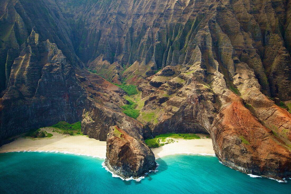 'Blue water and white sand in a small inlet along a rugged coastline;Hawaii united states of america'