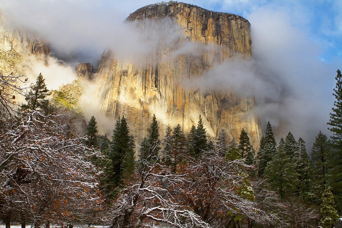 'Yosemite national park's el capitan (el cap) peaks through winter storm clouds during a december storm;California, united states of america'