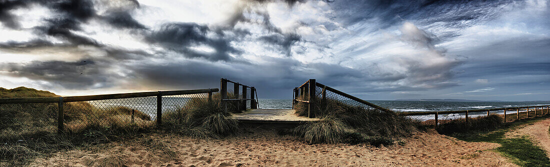 'Panoramic view of a boardwalk and fence on a beach at hengistbury head;Dorset england'
