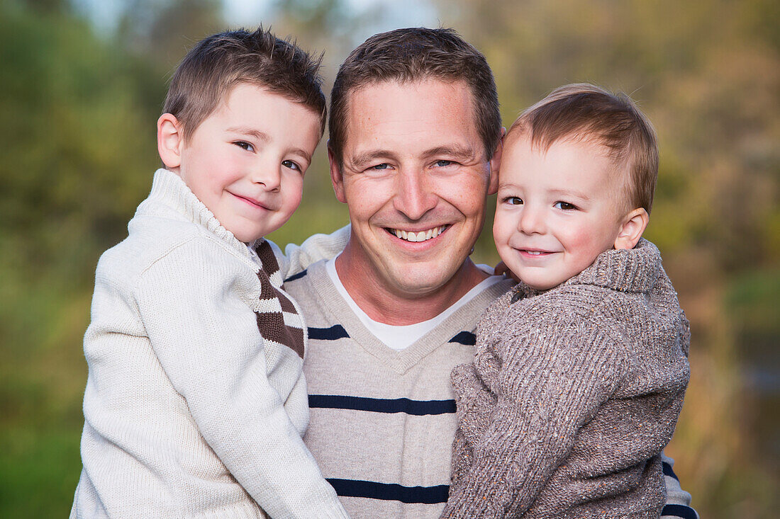 'Portrait of a father and two young sons;St. albert alberta canada'