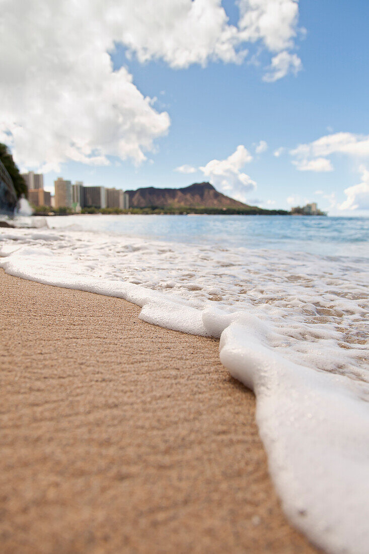 'View of waves coming onto the shore of waikiki beach with diamond head in the distance;Waikiki oahu hawaii united states of america'