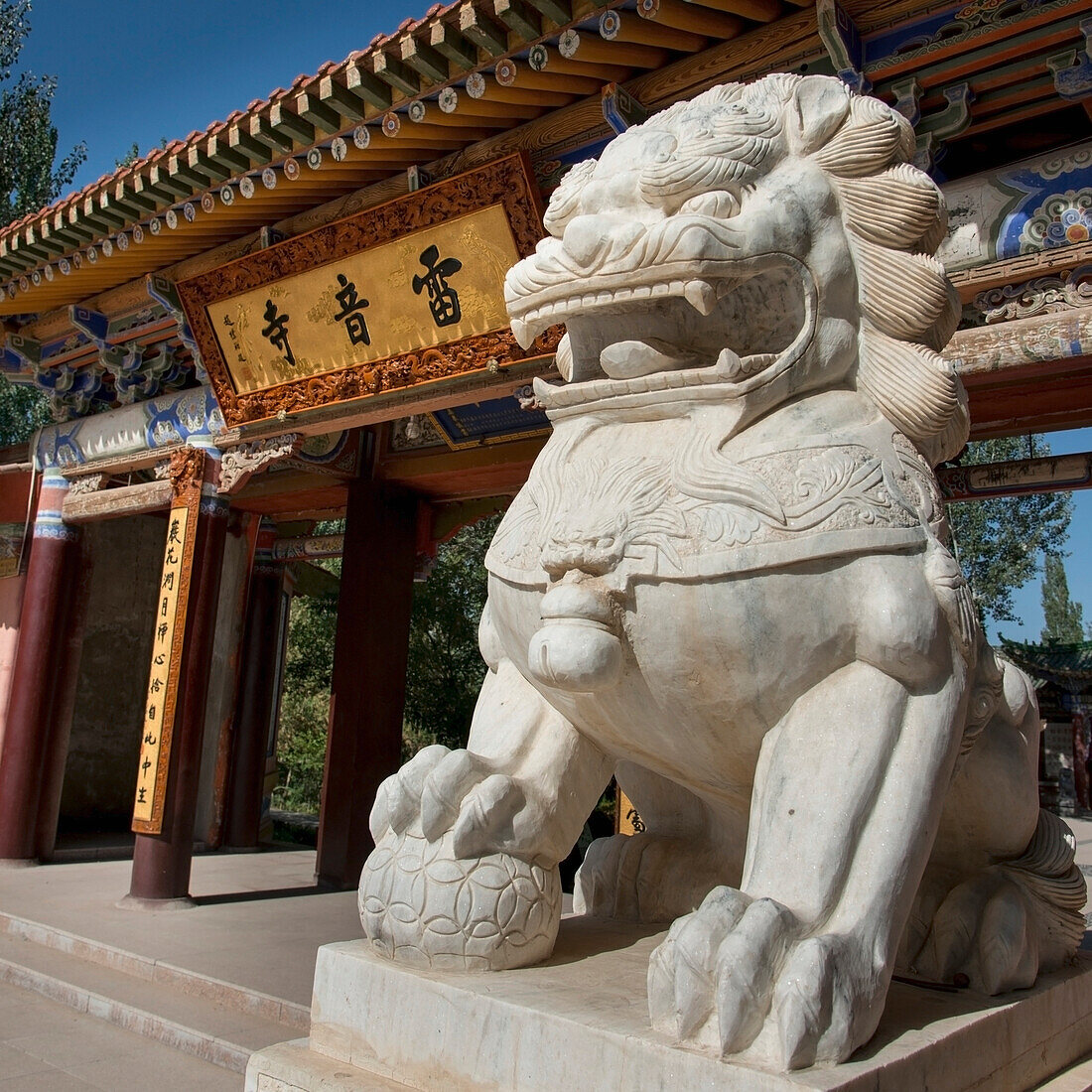 Close up of a lion statue outside a building in traditional japanese architecture