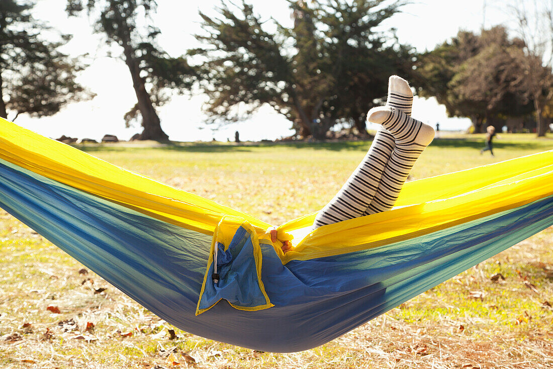 'Legs of a young girl sticking up out of a hammock;Crab cove california united states of america'
