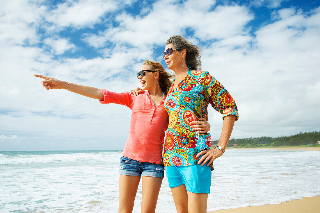 'A mother and daughter together on the beach; Kauai, Hawaii, United States of America'