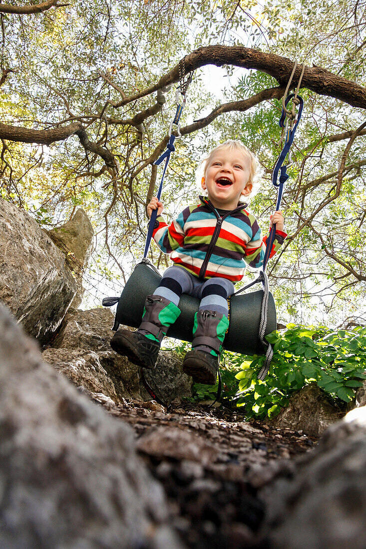 Boy (2 years) swinging, Taormina, Messina, Sicily, Italy