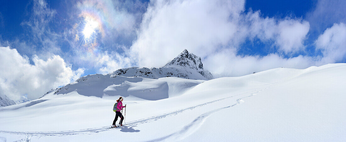 Female ski tourer ascending to Piz Sasuret, Piz Sasuret, Albula Alps, Engadin, Canton of Graubuenden, Switzerland