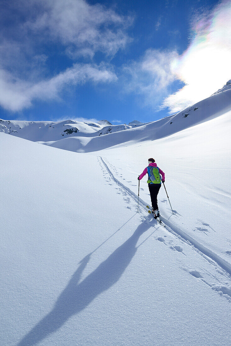 Female back-country skier ascending to Piz Laschadurella, Sesvenna Alps, Engadin, Graubuenden, Switzerland