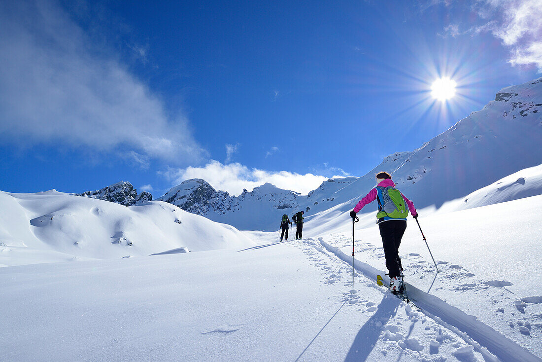 Three back-country skiers ascending to Piz Laschadurella, Sesvenna Alps, Engadin, Graubuenden, Switzerland