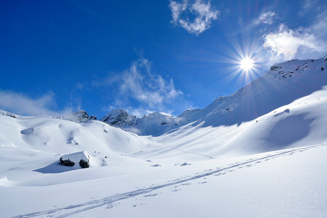 Ski track in snow, Piz Laschadurella in background, Sesvenna range, Engadin, Graubuenden, Switzerland