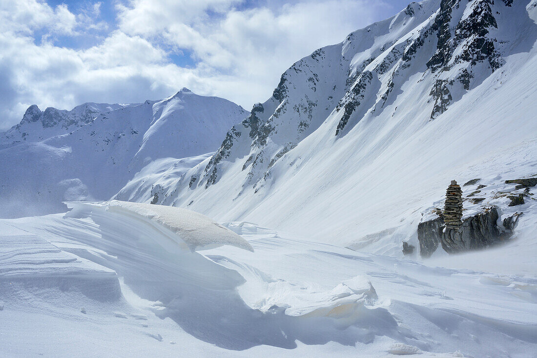 Snow erosion and cairn with Pfaffennock in background, Fuenfte Hornspitze, valley of Ahrntal, Zillertal range, South Tyrol, Italy